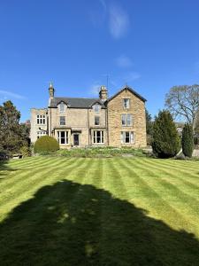 a large brick house with a large grass yard at The Beeches - Chatsworth Apartment No 5 - Sleep2 in Baslow