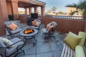 a patio with chairs and a fire pit on a balcony at SpringHill Suites Ridgecrest in Ridgecrest