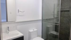 a bathroom with a toilet and a sink and a shower at HOTEL GALLERY URBAN in Bogotá