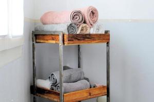 a stack of towels on a shelf in a room at Barlis - stilvolle Ferien in typischem Dorfhaus in Alpnach