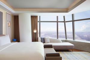 Postel nebo postele na pokoji v ubytování The Ritz-Carlton, Harbin