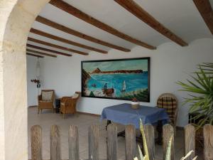 um quarto com uma mesa e um quadro na parede em Casa Maria Cecília em Xàbia