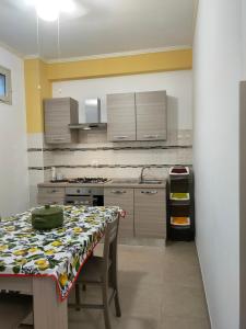 une cuisine avec une table et un chiffon de table. dans l'établissement CASA 3T a Isola a 15 min dal centro di Palermo, à Isola delle Femmine