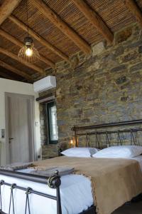 A bed or beds in a room at by karakas Λίθινο