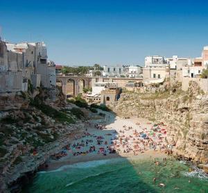 a group of people on a beach in the water at Casa Aurora in Polignano a Mare