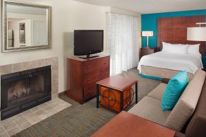 a hotel room with a bed and a television at Residence Inn Seattle South/Tukwila in Tukwila