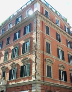 a large brick building with windows on the side of it at c-hotels Fiume in Rome