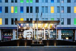 a hotel with a sign in front of a building at Aloft Riyadh Hotel in Riyadh