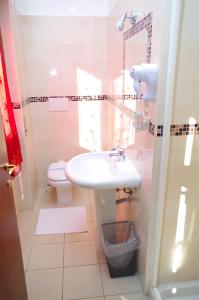 a bathroom with a sink and a toilet at Hotel Centrale in Milan