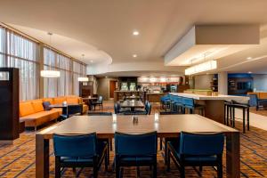 a hotel lobby with tables and chairs and a bar at Courtyard Philadelphia Great Valley/Malvern in Malvern