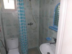 a bathroom with a shower and a toilet and a sink at Dom gościnny Moana in Pobierowo