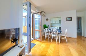 a kitchen and dining room with a table and chairs at Apartment Frane in Baška