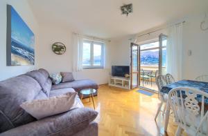 a living room with a couch and a table at Apartment Frane in Baška