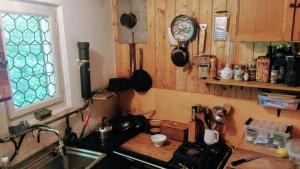 a kitchen with a stove and a sink and a window at Waldhaus auf dem Randen, Kanton Schaffhausen 