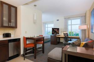a hotel room with a kitchen and a living room at Residence Inn by Marriott San Jose Airport in San Jose