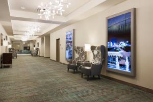 a waiting room with chairs and a painting on the wall at Residence Inn by Marriott San Jose Airport in San Jose