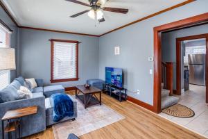 a living room with a couch and a tv at Spacious Home with In-Unit Laundry, Parking, 1GB WiFi, & Patio Deck in Rochester