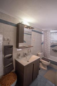a bathroom with a sink and a toilet at Apartment with view in Kiveri, near Nafplio in Kivérion