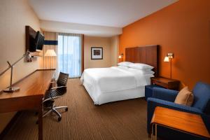 a hotel room with a bed and a desk and a desk at Four Points by Sheraton San Jose Airport in San Jose