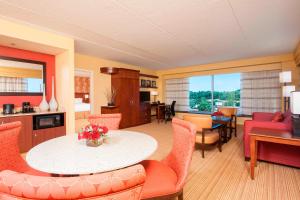 a kitchen and living room with a table and chairs at Courtyard Peoria Downtown in Peoria