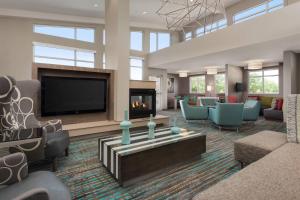a large living room with a fireplace and a tv at Residence Inn by Marriott Shreveport-Bossier City/Downtown in Bossier City