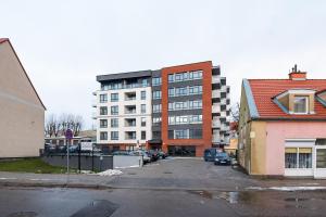 a large building with a parking lot in front of it at Apartamenty Glamour Giżycko in Giżycko