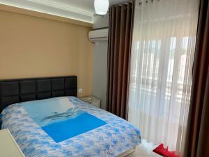 a bedroom with a bed and a window at Queen Isabella Premium in Vlorë