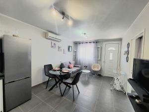 a living room with a table and a couch at Villa Gardiki for2 in Halikounas