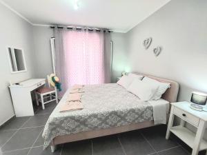 a small bedroom with a bed and a window at Villa Gardiki for2 in Halikounas
