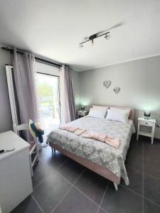 a bedroom with a bed and a large window at Villa Gardiki for2 in Halikounas
