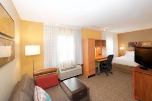 a hotel room with a bed and a couch and a desk at TownePlace Suites by Marriott Seattle Everett/Mukilteo in Mukilteo