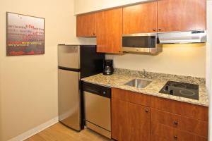 a small kitchen with a sink and a refrigerator at TownePlace Suites by Marriott Seattle Everett/Mukilteo in Mukilteo