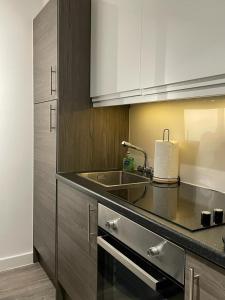 a kitchen with a sink and a counter top at The Phoenix Collection in Liverpool