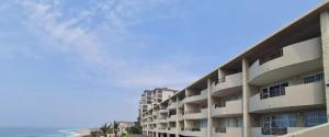 an apartment building with the ocean in the background at Blue Largo Sea View in Westbrook