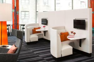 a waiting room with white chairs and orange pillows at Courtyard by Marriott New York Manhattan/Central Park in New York