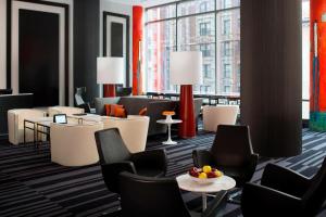 a hotel lobby with chairs and tables and windows at Courtyard by Marriott New York Manhattan/Central Park in New York