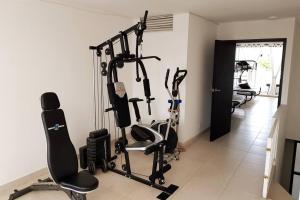 a gym with several tread machines in a room at Casa al sur de Cali. Grupos/Familias/Deportistas! in Cali