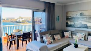 a living room with a couch and a table at Salinetas Terraza Playa in Telde