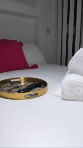 a tray sitting on top of a bed with towels at The Phoenix Collection in Liverpool