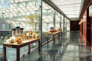 a corridor of a building with tables with fruit on them at Courtyard by Marriott Mexico City Airport in Mexico City