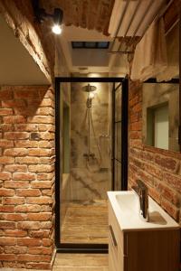 a bathroom with a shower and a white sink at CASA GALATA 35 in Istanbul