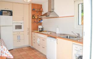 a kitchen with white appliances and a sink at 3 Bedroom Lovely Home In Hendaye in Hendaye