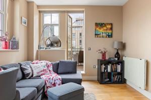 a living room with a couch and a chair at Westminster Big Ben Apartment in London