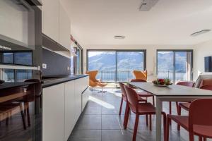a kitchen and dining room with a table and chairs at Apartment Lana - Gera Lario in Gera Lario