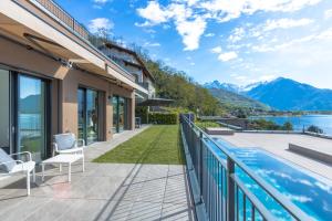 a balcony with a view of the water and mountains at Apartment Lana, Gera Lario in Gera Lario