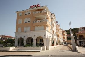a building with a hotel sign on top of it at Hotel Trogir Palace in Trogir