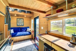 una casetta minuscola con un letto blu e una finestra di Abingdon Vacation Rental Tiny Home on 10-Acre Farm ad Abingdon