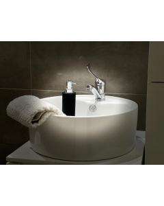 a white sink with a faucet in a bathroom at Apartman Jelena in Sremska Mitrovica