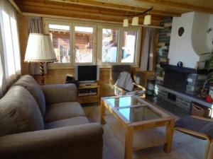 a living room with a couch and a coffee table at Chalet Stefanino, 3 12 Zimmer in Bellwald