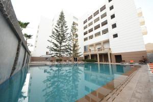 a swimming pool in front of a building at Agyad Maroc Appart-Hotel in Agadir